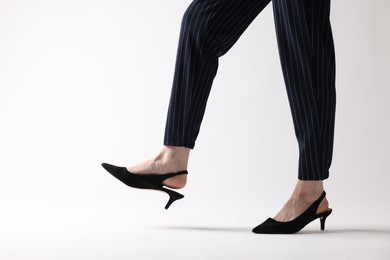 Photo of Businesswoman in black shoes on white background, closeup