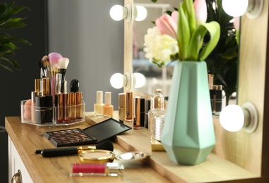 Photo of Dressing table with set of luxury cosmetic products. Interior element