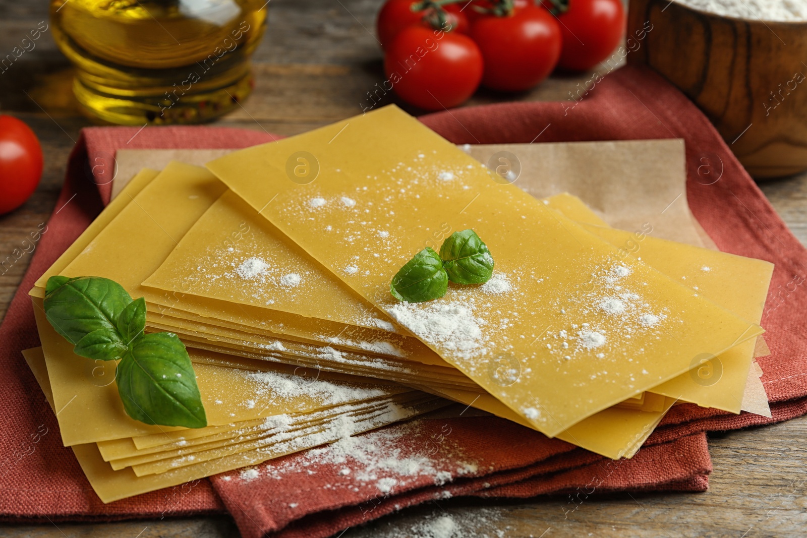 Photo of Composition with uncooked lasagna sheets on wooden table