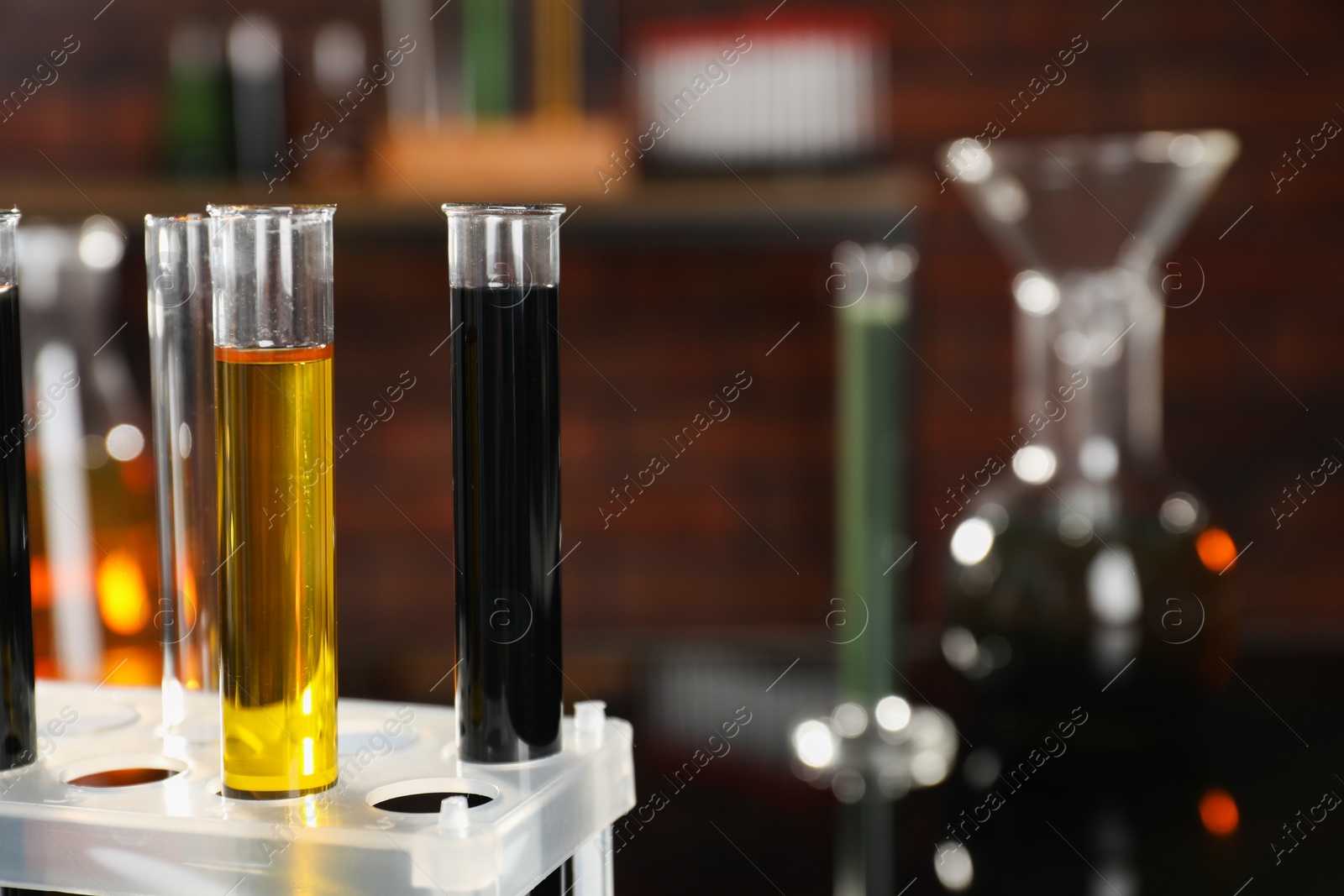 Photo of Laboratory glassware with different types of oil, closeup