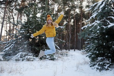 Photo of Cheerful woman enjoying winter day in forest