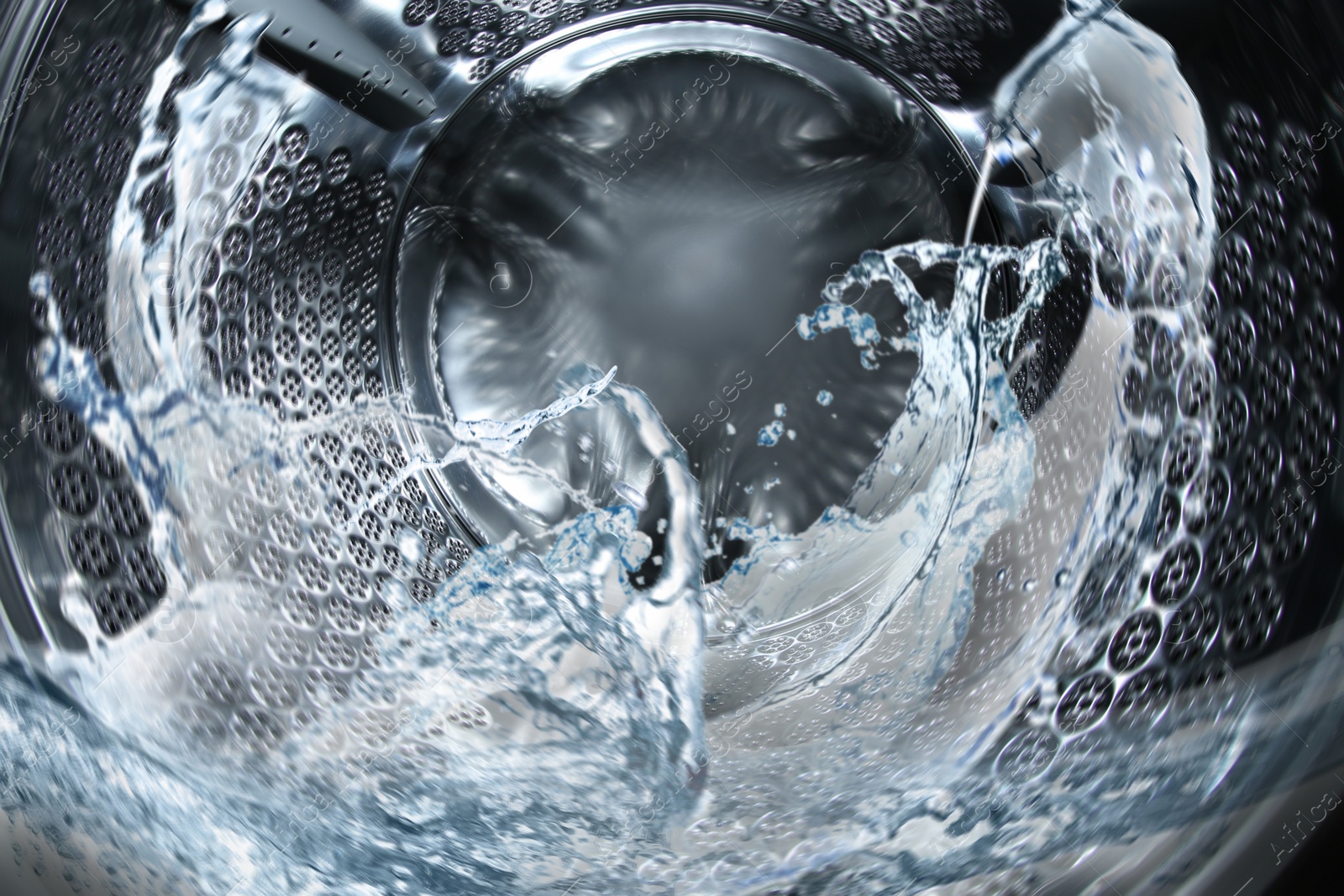 Image of Washing machine drum with water, closeup view