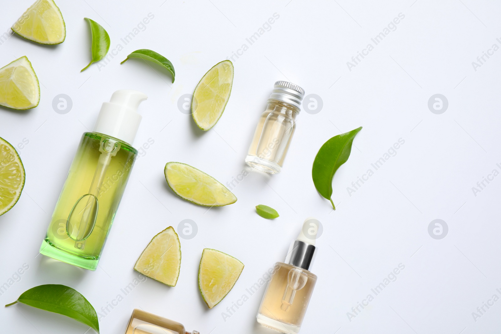 Photo of Composition with lime essential oil on white background, top view