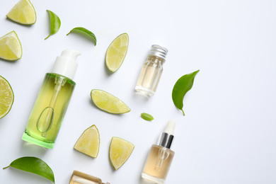 Composition with lime essential oil on white background, top view