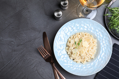 Photo of Delicious risotto with cheese on grey table, flat lay. Space for text