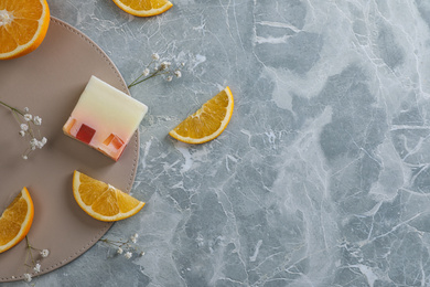 Photo of Flat lay composition with soap and orange slices on light grey marble background. Space for text