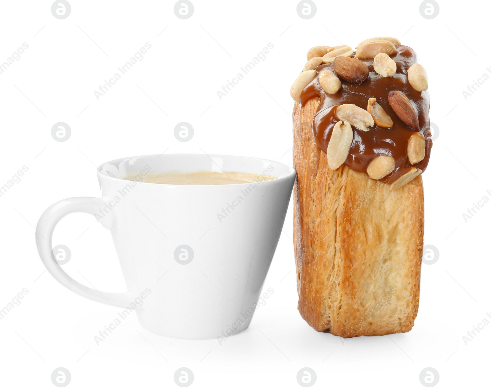 Photo of Round croissant with chocolate paste, nuts and cup of drink isolated on white. Tasty puff pastry