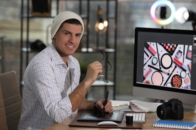 Photo of Professional retoucher working on computer in office