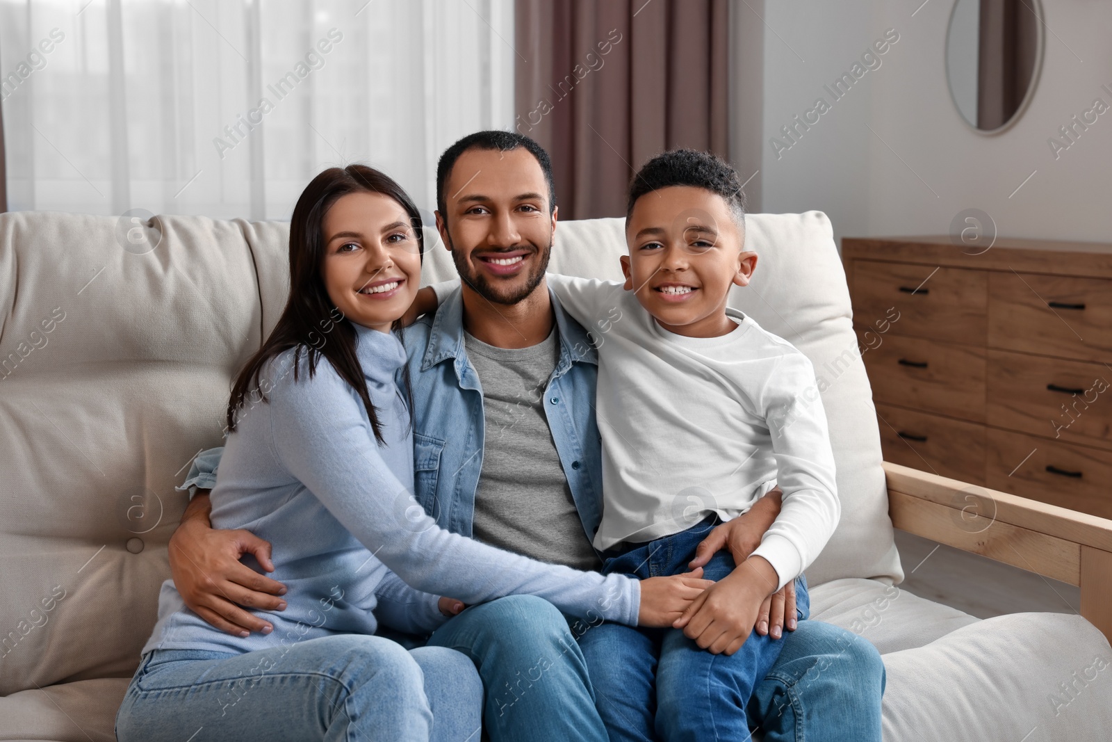 Photo of Happy international family on sofa at home