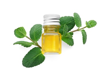 Photo of Bottle with mint essential oil and fresh herb on white background