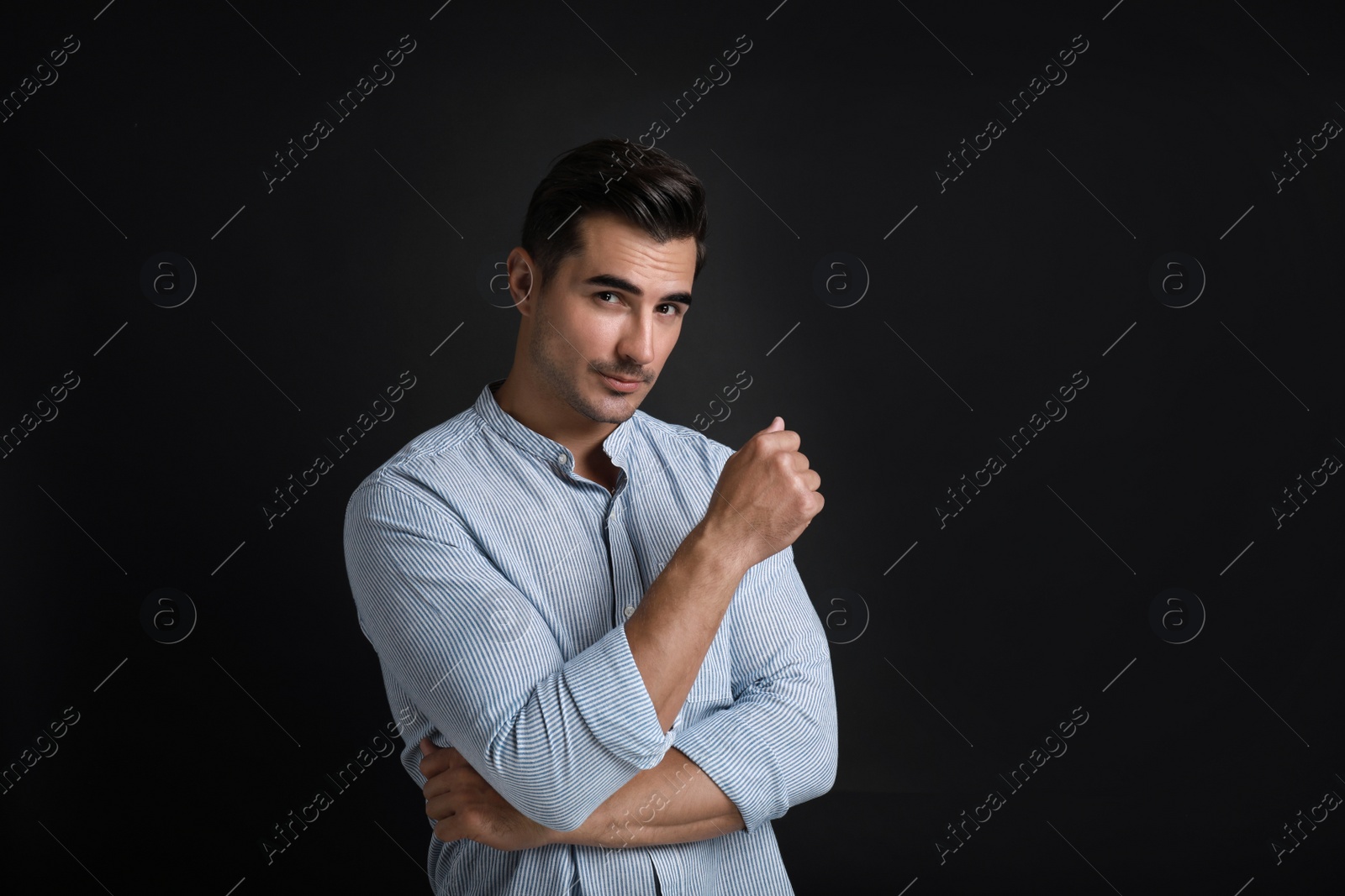 Photo of Portrait of handsome young man on black background