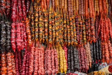 Photo of Bunches of different delicious churchkhelas at market