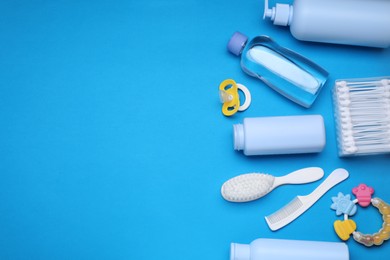 Photo of Flat lay composition with baby care products and accessories on light blue background, space for text
