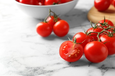 Photo of Fresh cherry tomatoes on marble background. Space for text