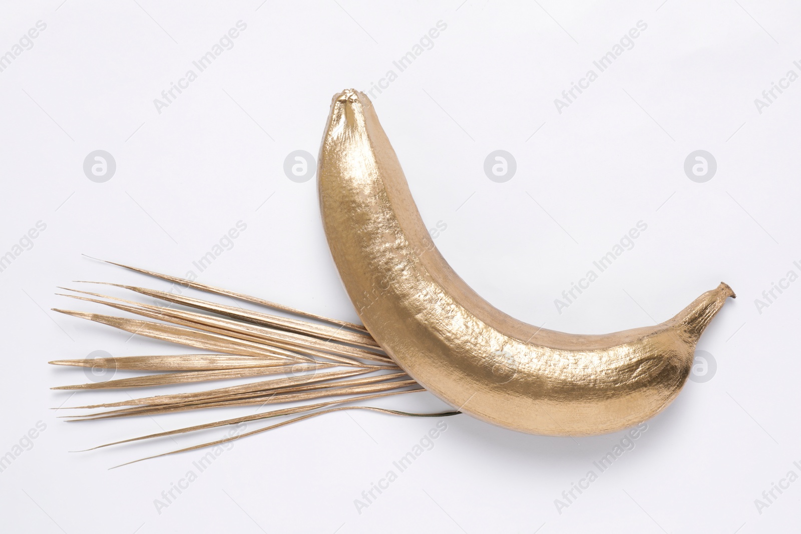 Photo of Shiny golden wheat spike and banana on white background, top view. Decor elements