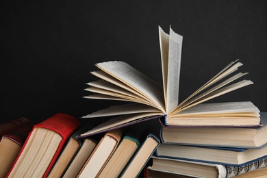 Stack of hardcover books on black background