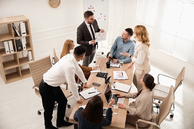 Photo of Businesspeople having meeting in office. Management consulting