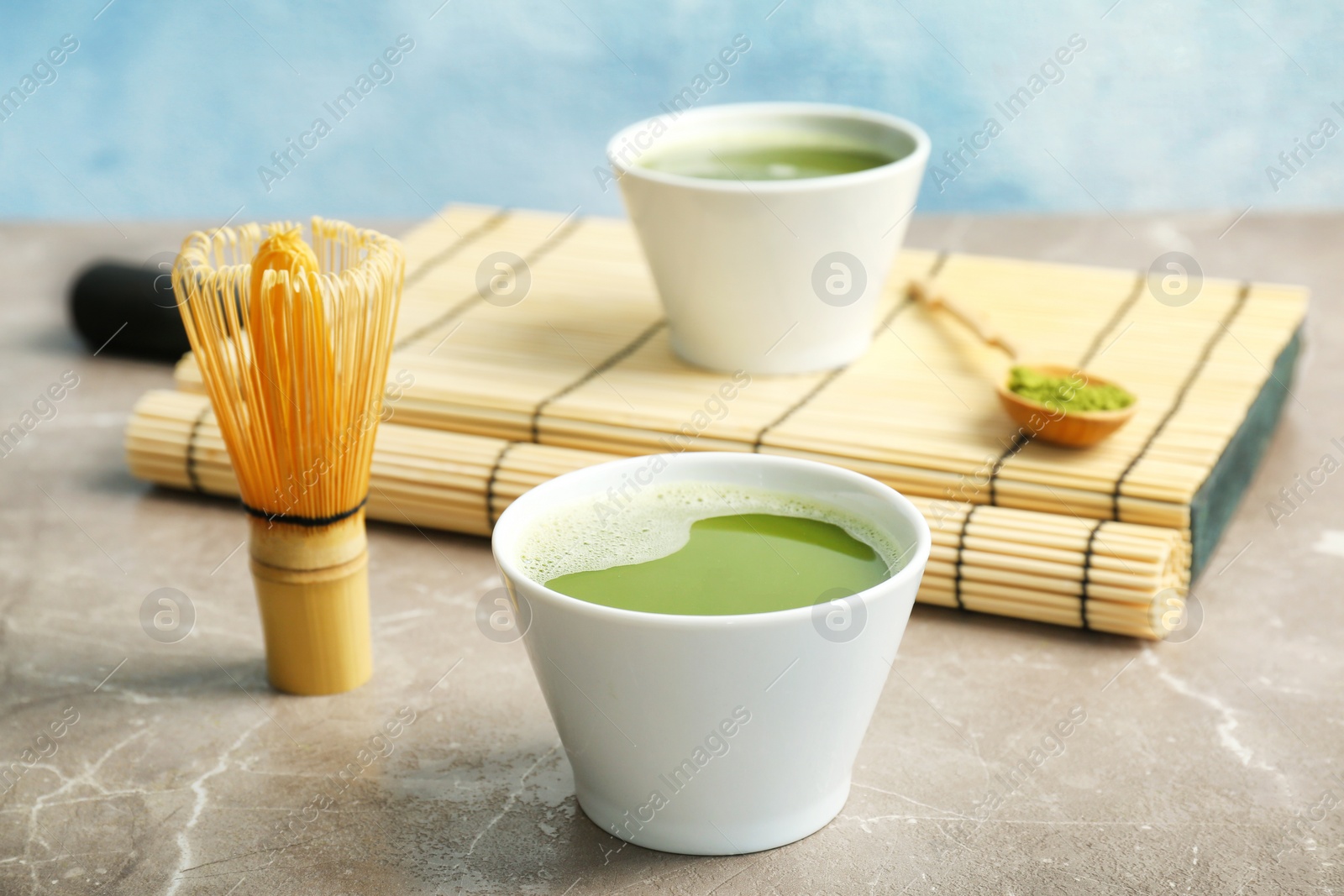 Photo of Chawan with fresh matcha tea and chasen on table