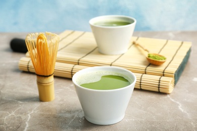 Chawan with fresh matcha tea and chasen on table