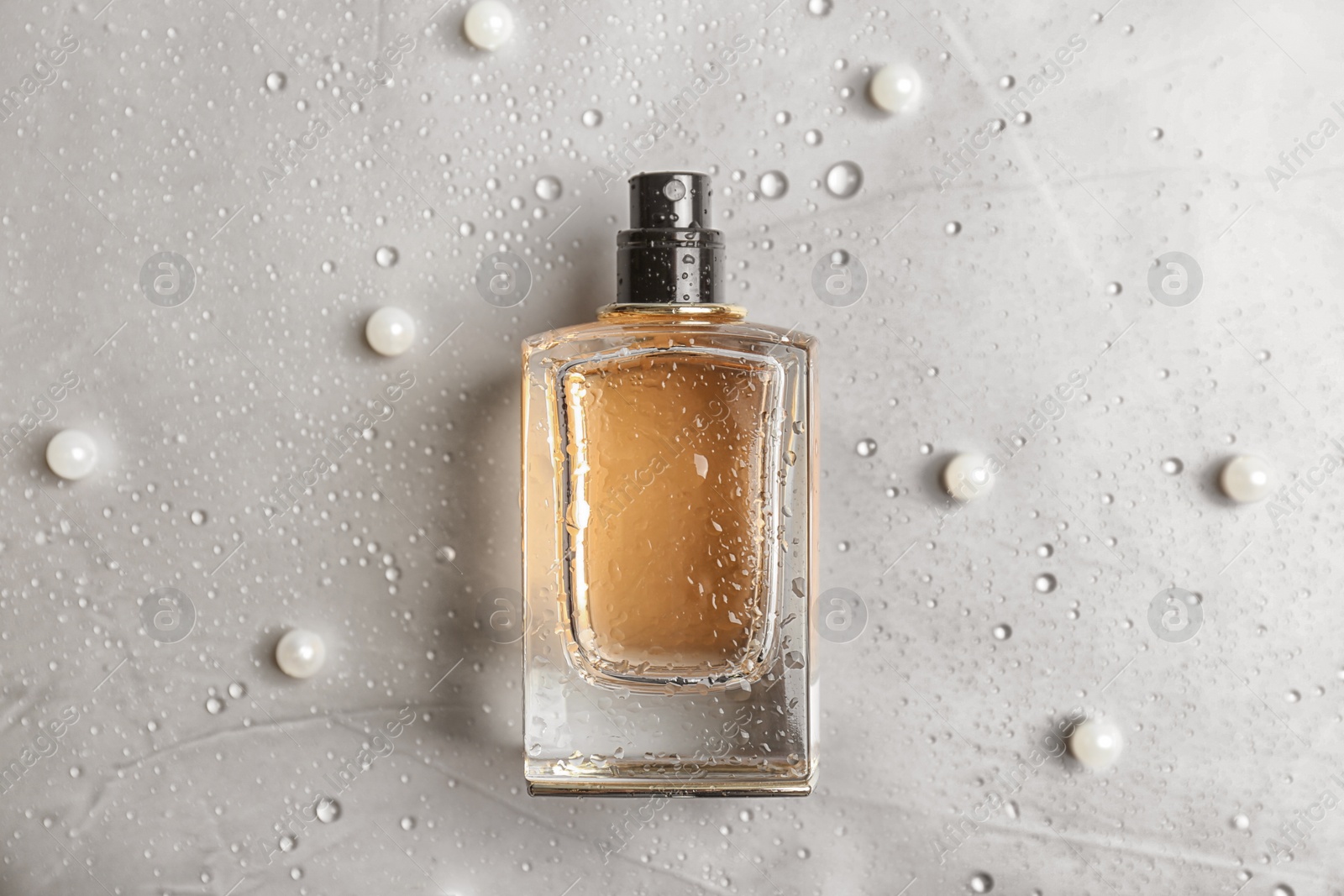 Photo of Perfume bottle on light background, flat lay