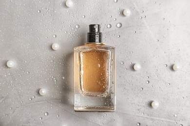 Photo of Perfume bottle on light background, flat lay