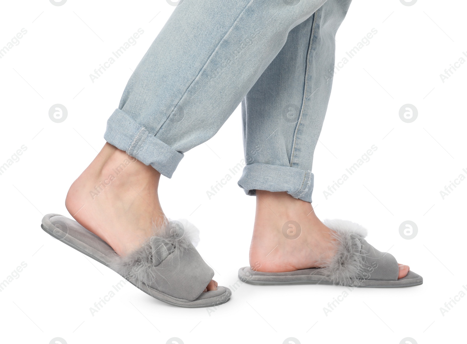 Photo of Woman in grey soft slippers on white background, closeup