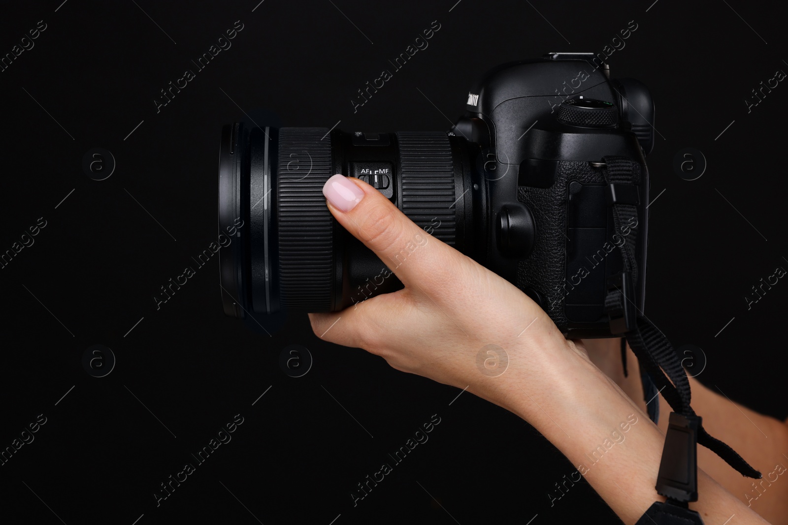 Photo of Photographer with camera on black background, closeup