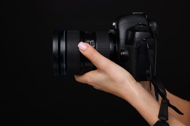 Photo of Photographer with camera on black background, closeup