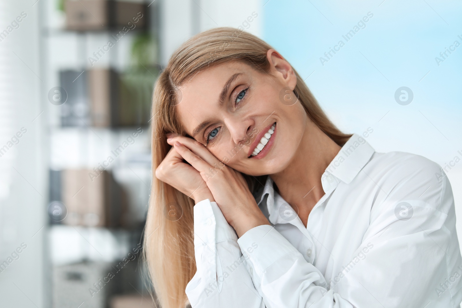 Photo of Portrait of smiling woman in formal clothes. Charming blonde lady posing indoors