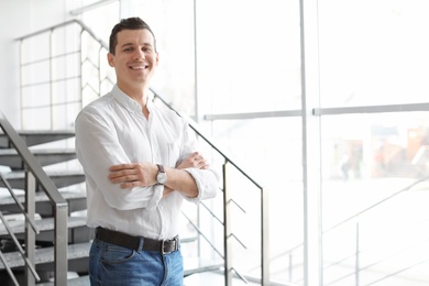 Photo of Portrait of confident man on stairs against window