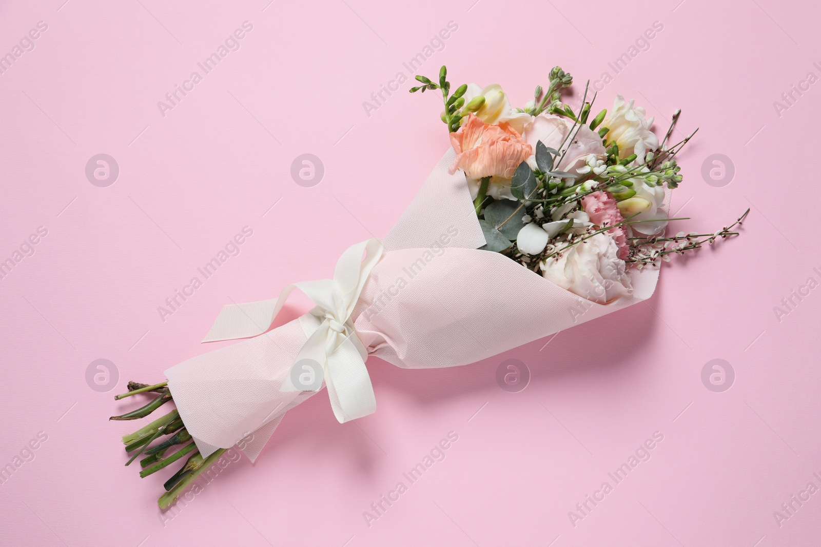 Photo of Bouquet of beautiful flowers on pink background, top view