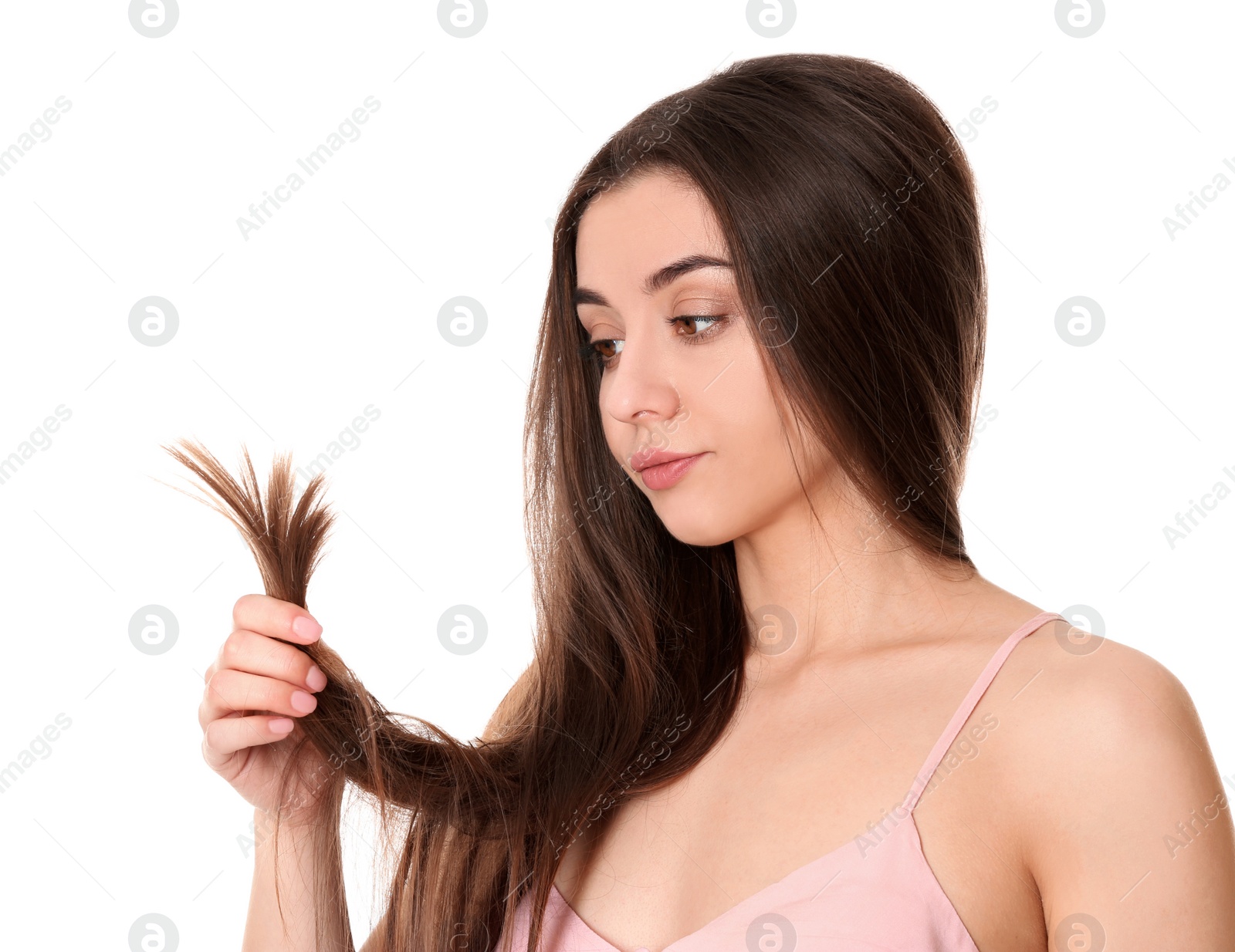 Photo of Emotional woman with damaged hair on white background. Split ends