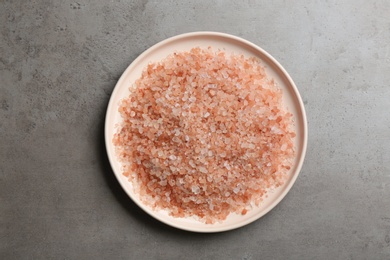 Photo of Pink himalayan salt on grey table, top view
