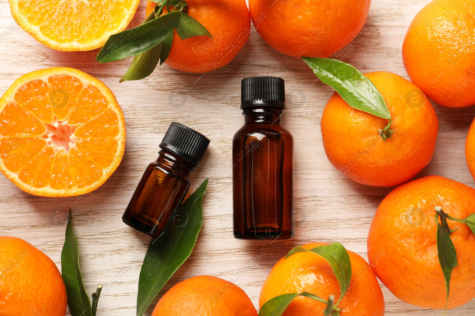 Photo of Flat lay composition with tangerine essential oil on wooden table