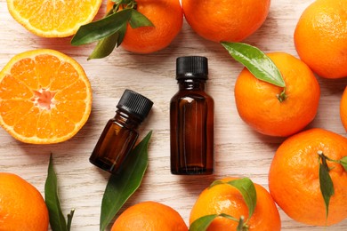 Photo of Flat lay composition with tangerine essential oil on wooden table