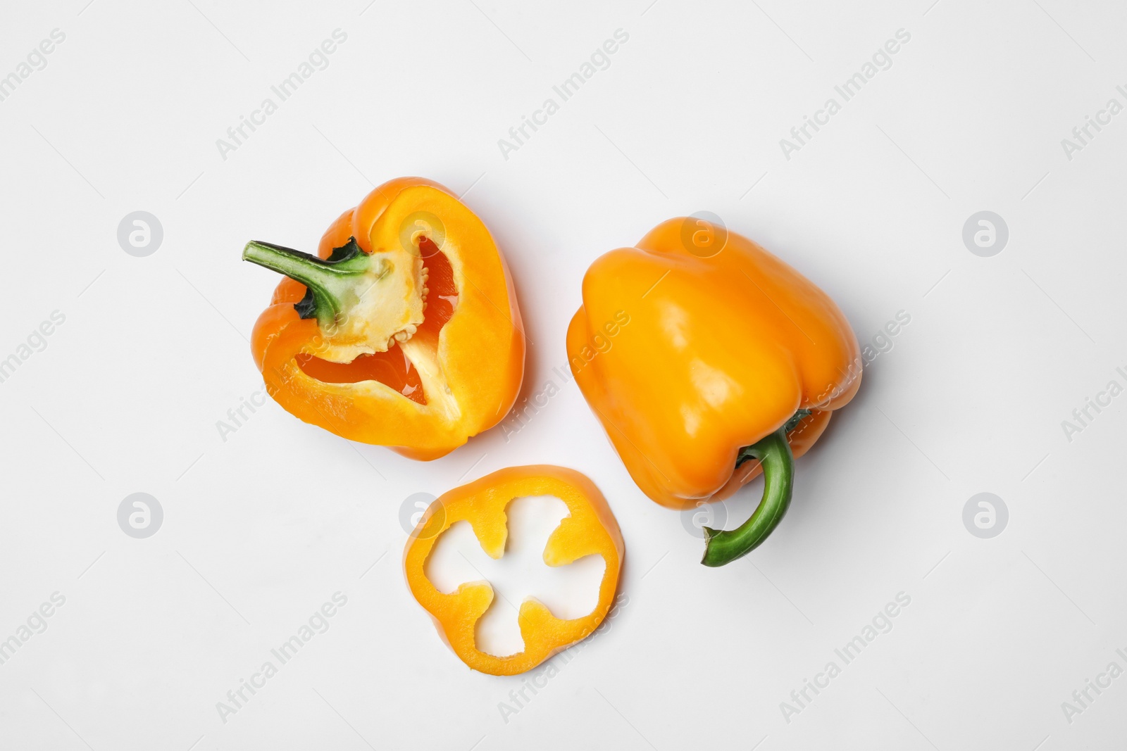 Photo of Fresh ripe bell peppers on white background, flat lay. Organic vegetables