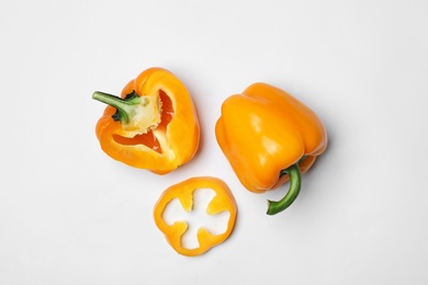 Photo of Fresh ripe bell peppers on white background, flat lay. Organic vegetables