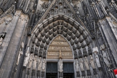 Photo of Cologne, Germany - August 28, 2022: Entrance of beautiful gothic cathedral outdoors