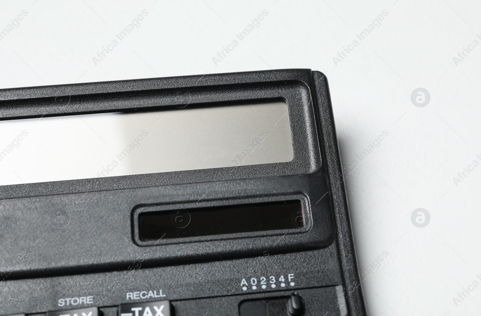 Photo of Calculator on white background, closeup. Tax accounting concept