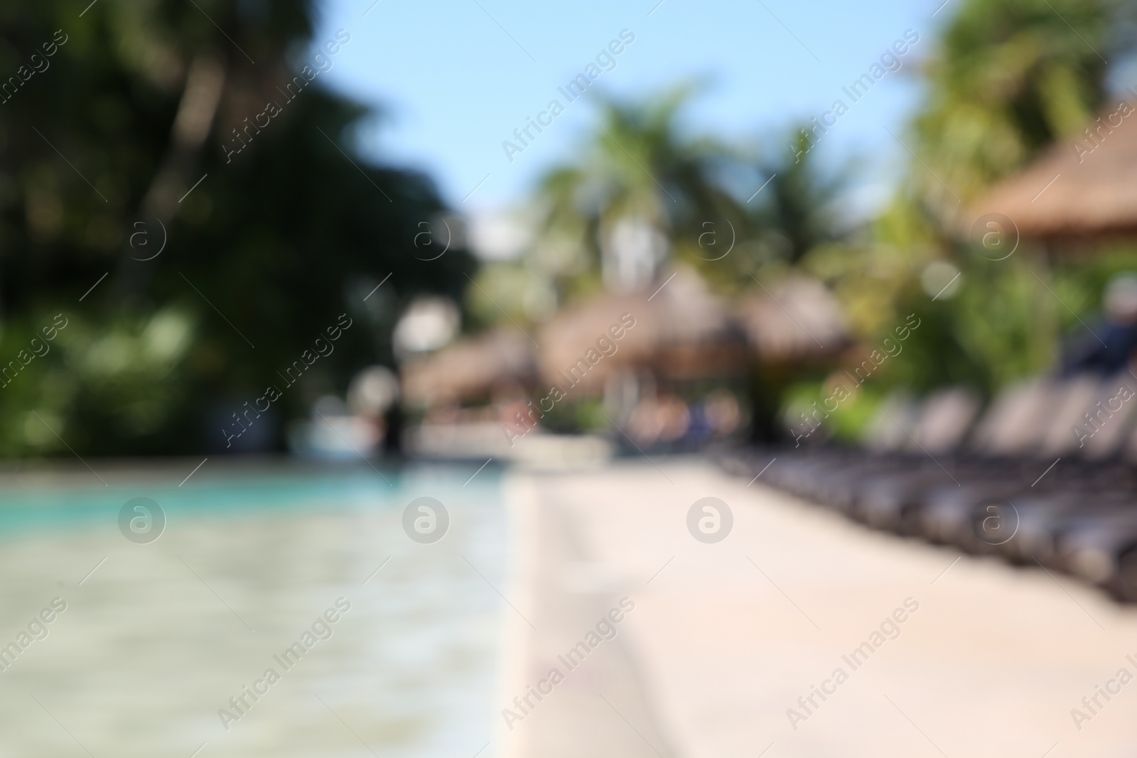 Photo of Blurred view of outdoor swimming pool at resort on sunny day