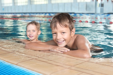 Photo of Cute little boys in indoor swimming pool
