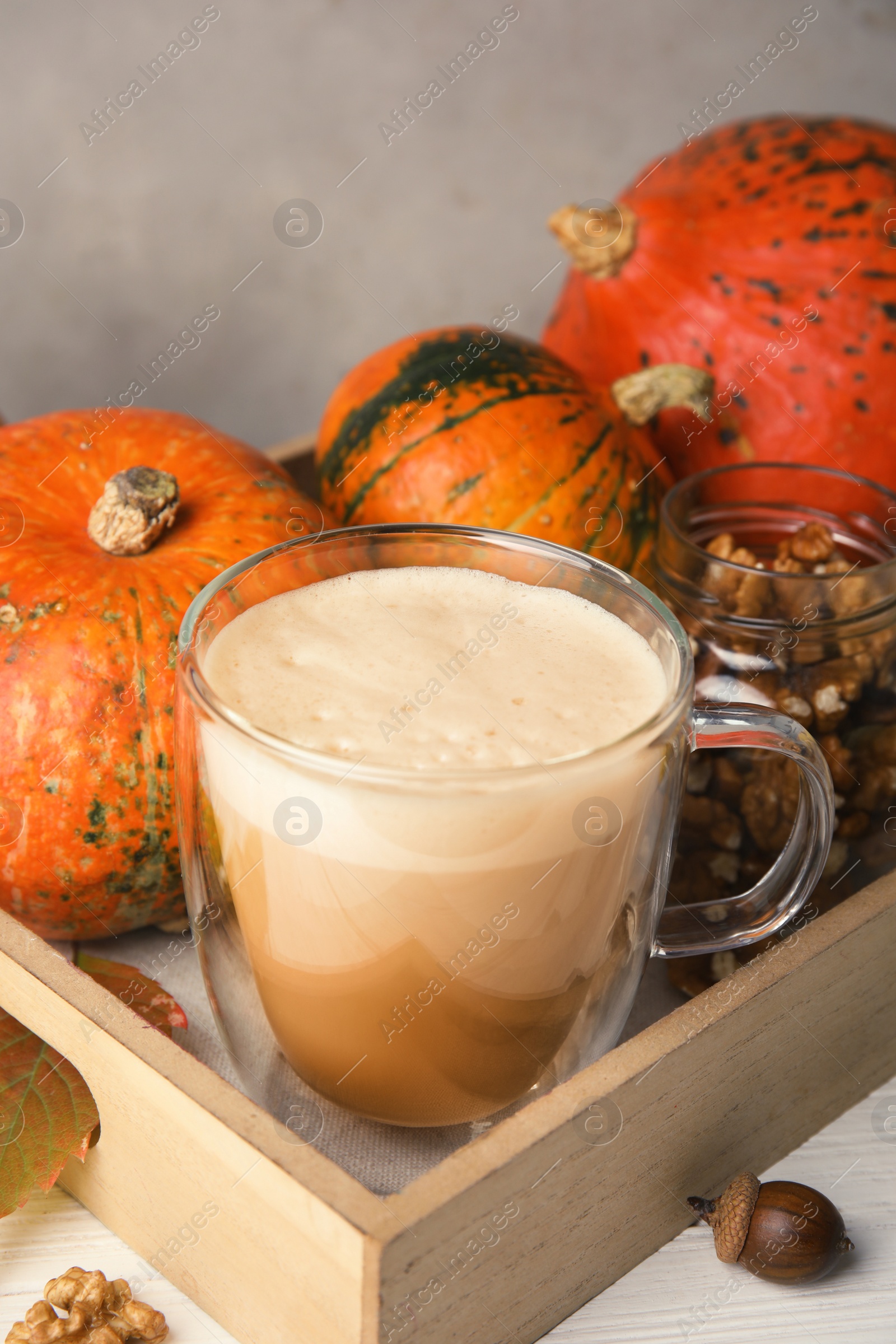 Photo of Composition with cup of tasty pumpkin spice latte on table