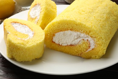 Photo of Pieces of delicious cake roll on table, closeup