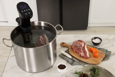 Photo of Pot with sous vide cooker and products on table indoors. Thermal immersion circulator