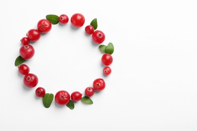 Photo of Frame made of fresh cranberries and green leaves on white background, flat lay. Space for text