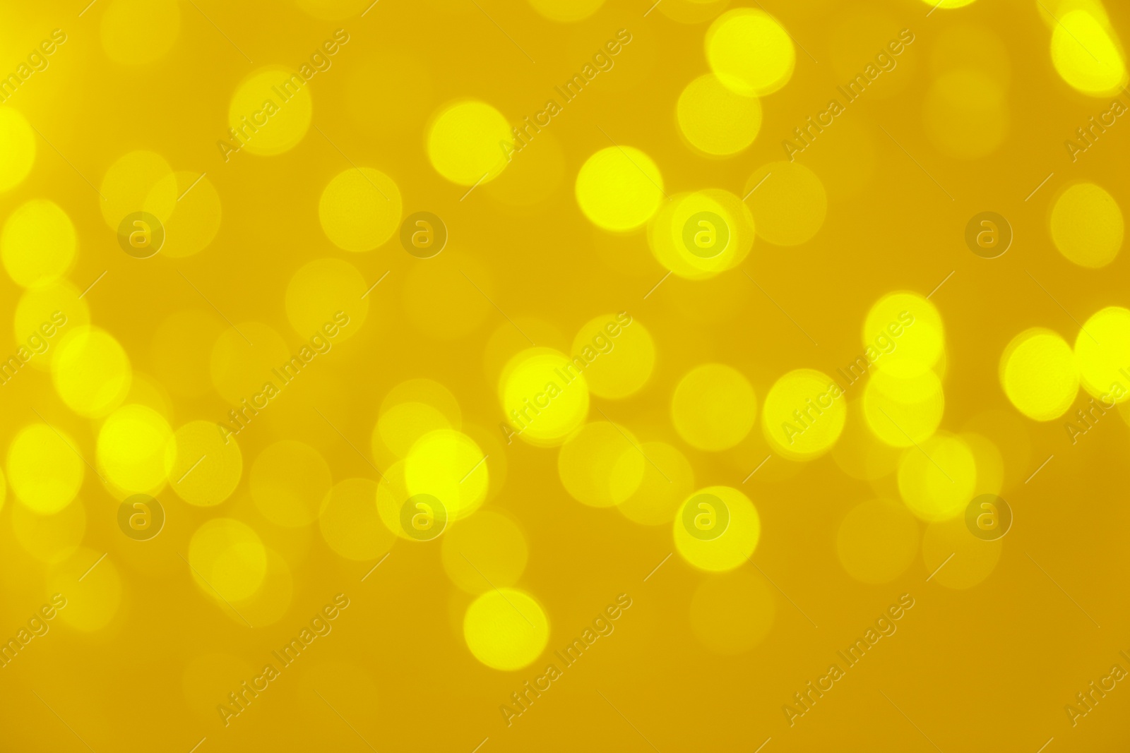 Photo of Blurred view of shiny gold lights. Bokeh effect