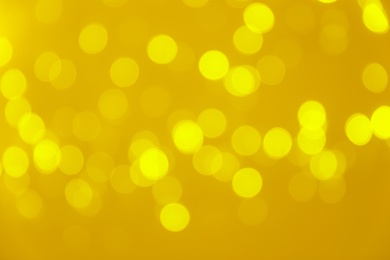 Photo of Blurred view of shiny gold lights. Bokeh effect