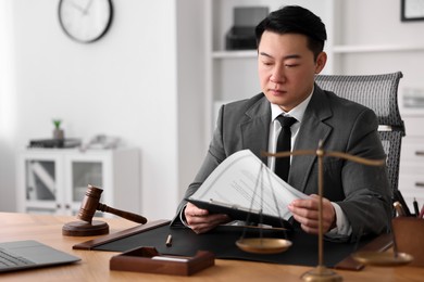 Photo of Notary working at wooden table in office, space for text