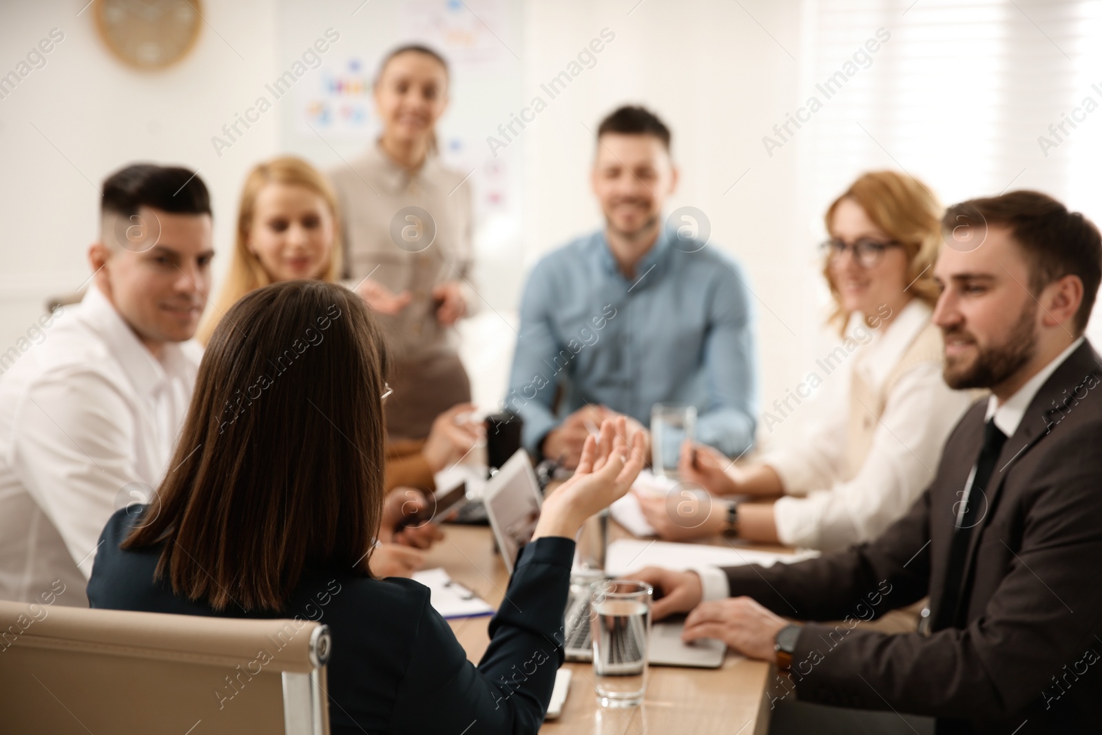 Photo of Businesspeople having meeting in office. Management consulting