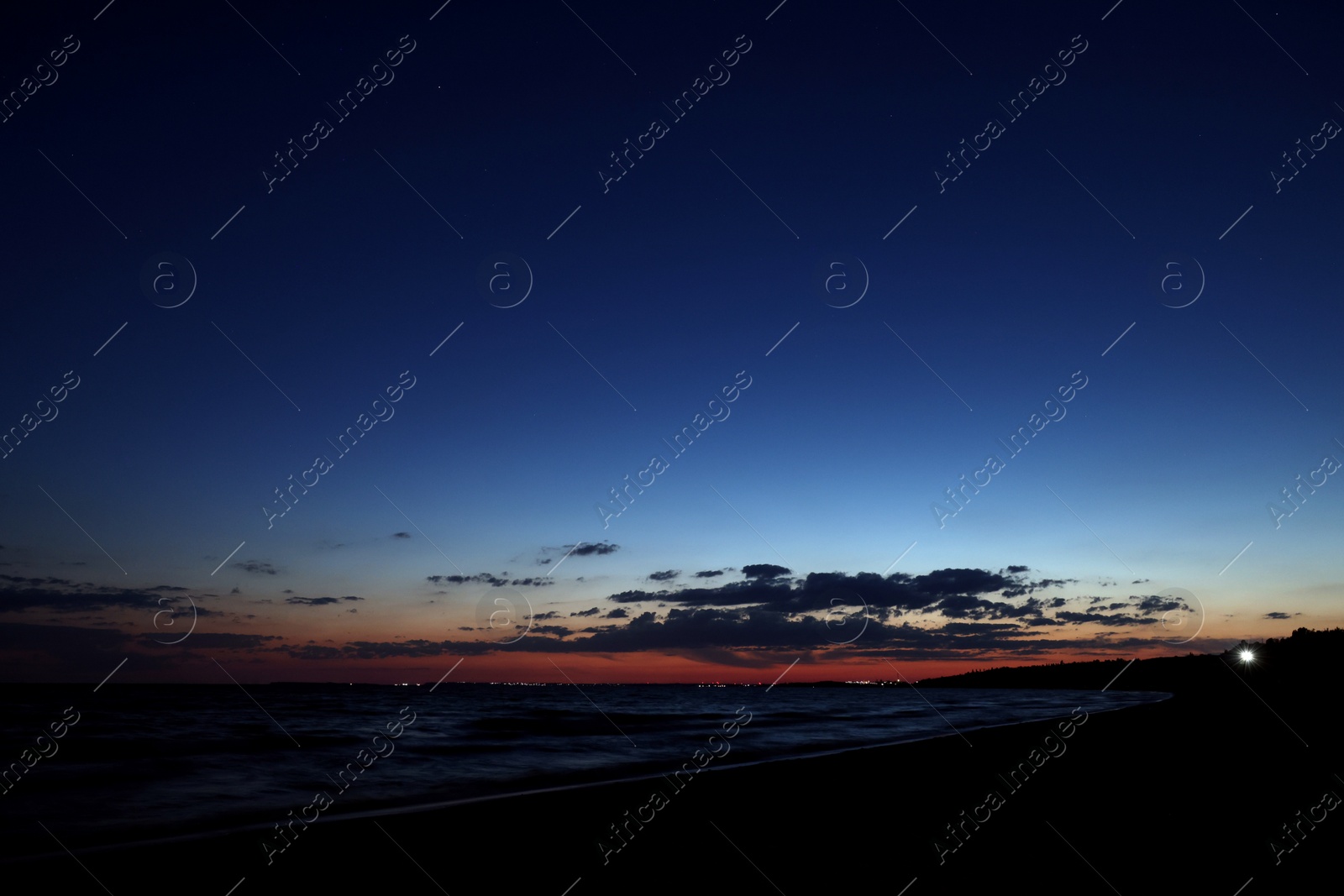 Photo of Picturesque view of beautiful sunset on seaside at night